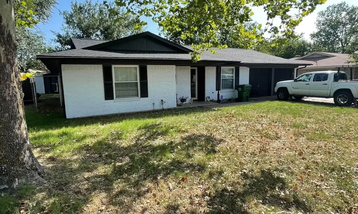 Professional roofing crew working on a residential roof in Monroe